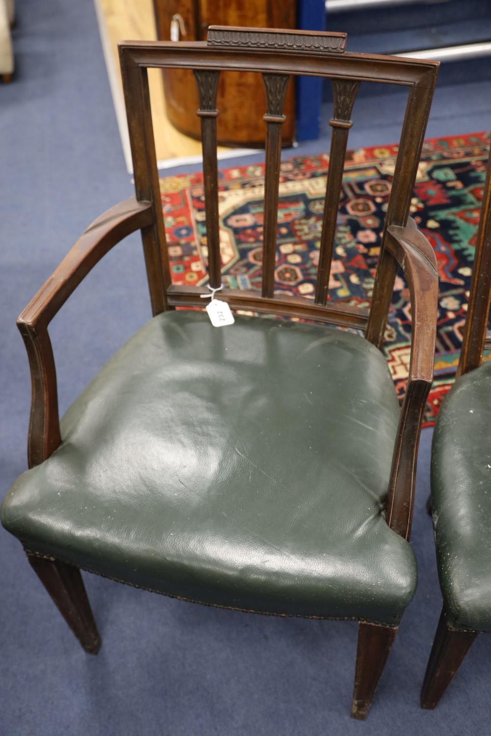 A set of six Hepplewhite style mahogany chairs (two with arms)